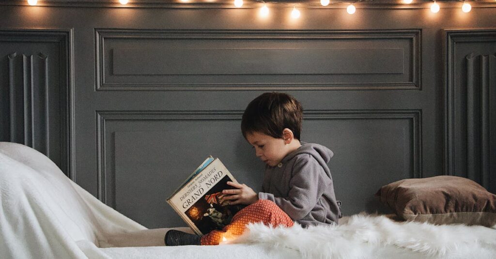 ๐ 5 Lifestyle Essentials Every Book Lover Needs A young boy reads a book in a cozy bedroom setting with warm string lights and soft textures.